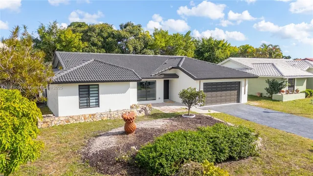 a front view of a house with a yard and outdoor seating