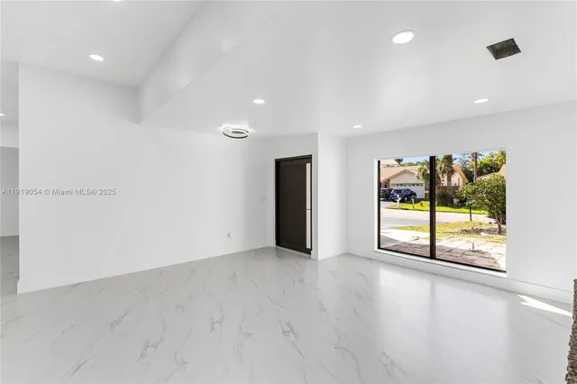 an empty room with windows and closet