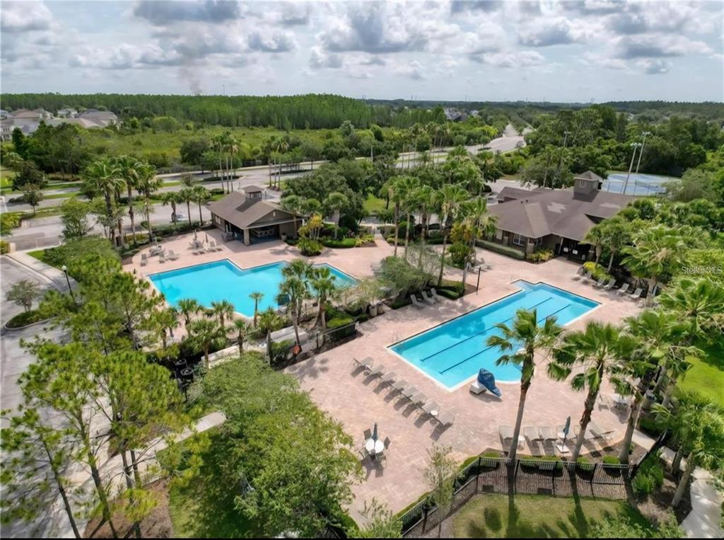 30517 Pecan Valley Loop Wesley Chapel, FL 33543 - Photo 14 of 15 an aerial view of a house with a garden and lake view