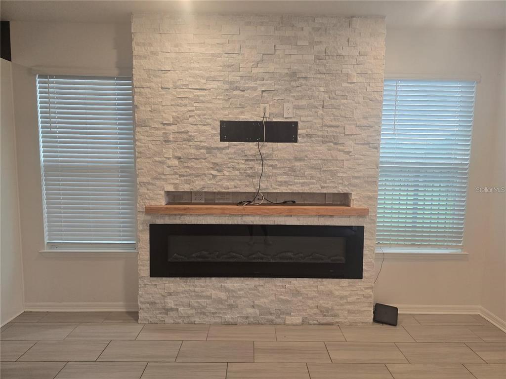 30517 Pecan Valley Loop Wesley Chapel, FL 33543 - Photo 5 of 15 a bathroom with a sink and a fireplace