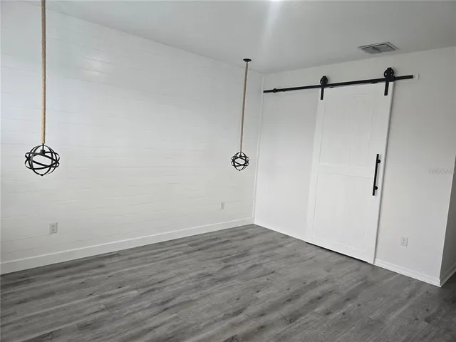 a view of a room with wooden floor