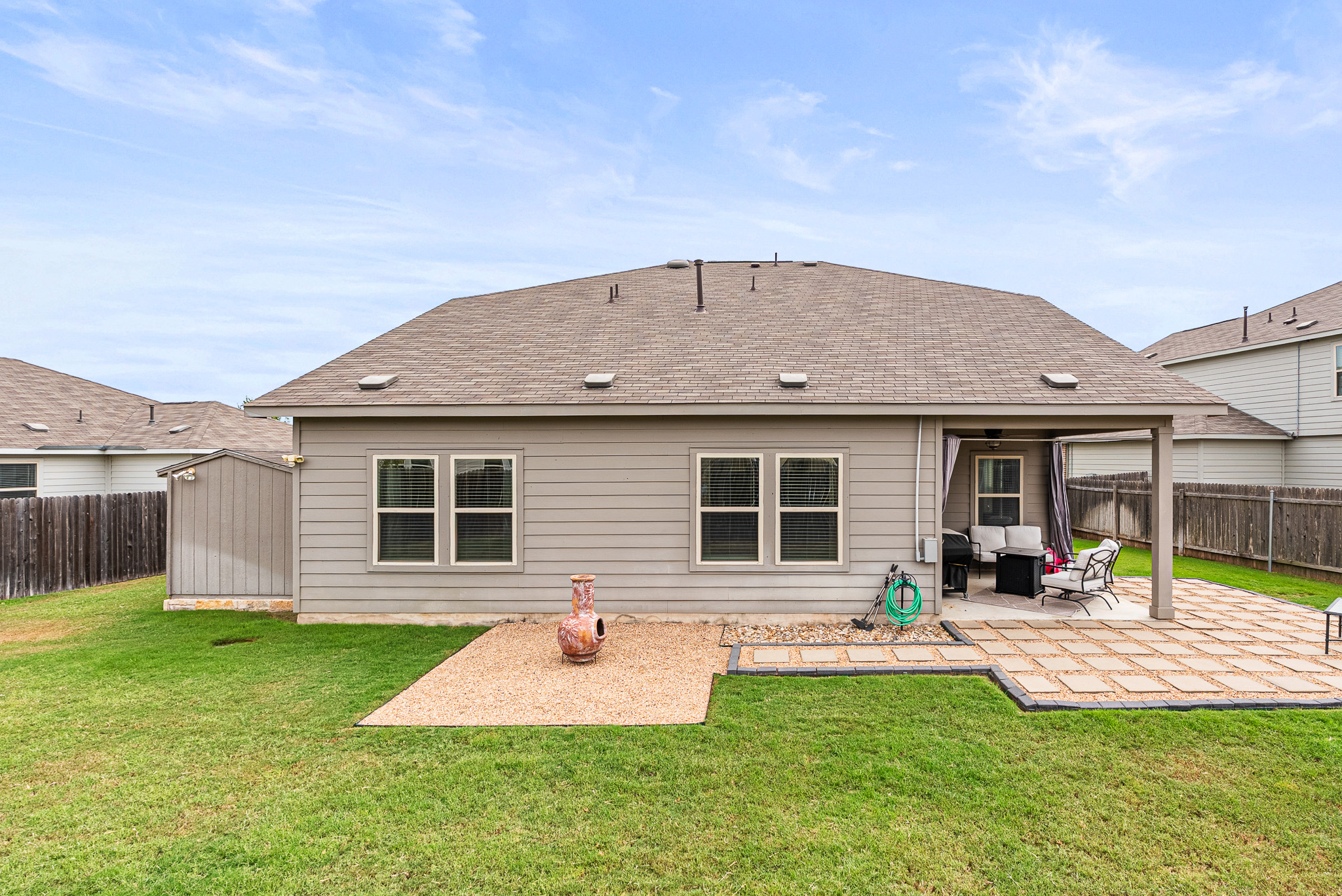 136 Copper Lane Kyle, TX 78640 - Photo 7 of 33 a front view of a house with a garden and patio