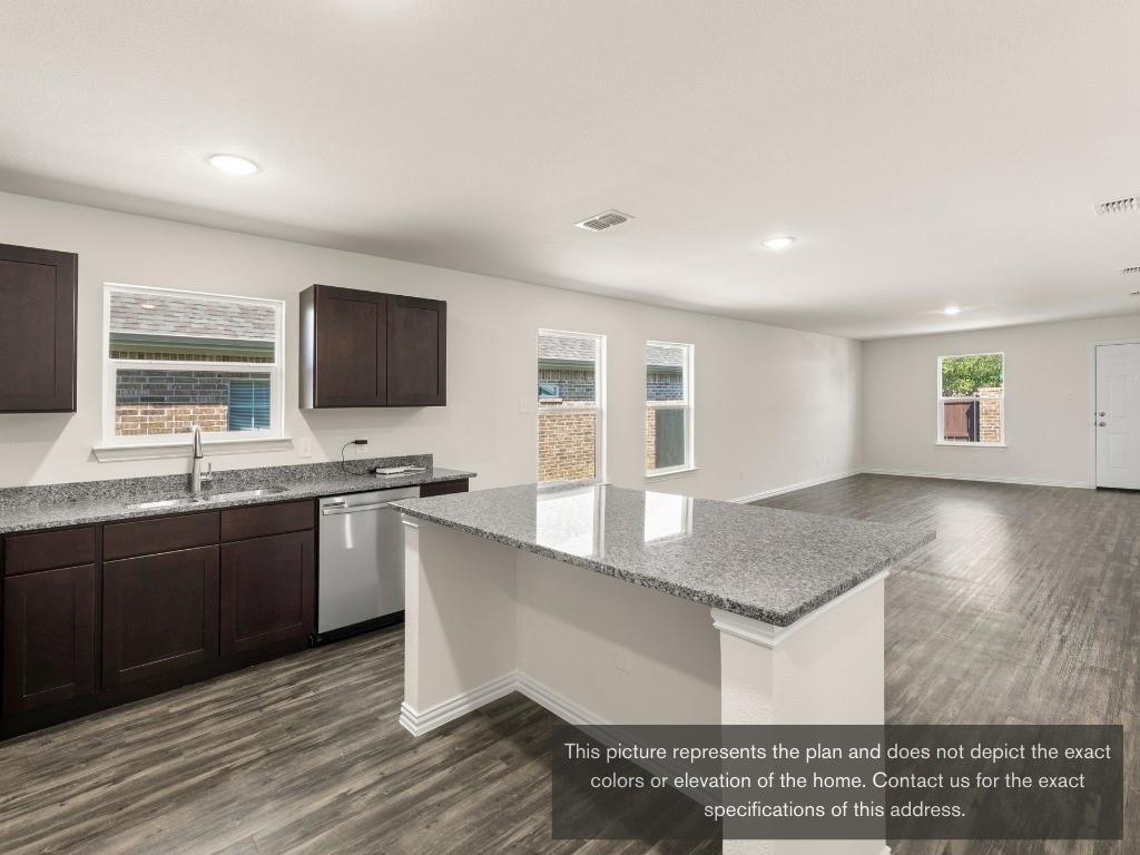 11433 Themis Court Lorena, TX 76655 - Photo 9 of 22 a large kitchen with kitchen island granite countertop a sink and a stove top oven