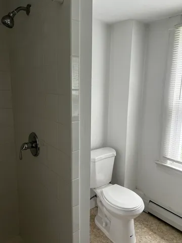 a white toilet sitting next to a bathroom sink