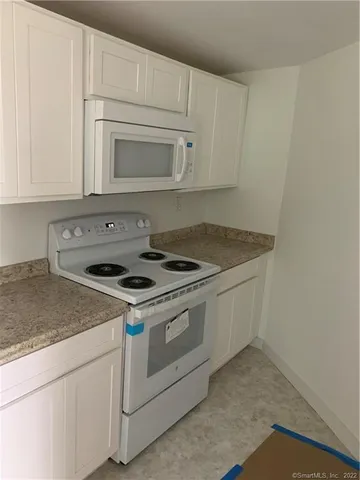 a stove top oven sitting inside of a kitchen