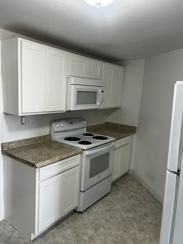 a kitchen with a stove and a microwave