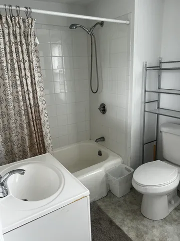 a bathroom with a toilet and a shower