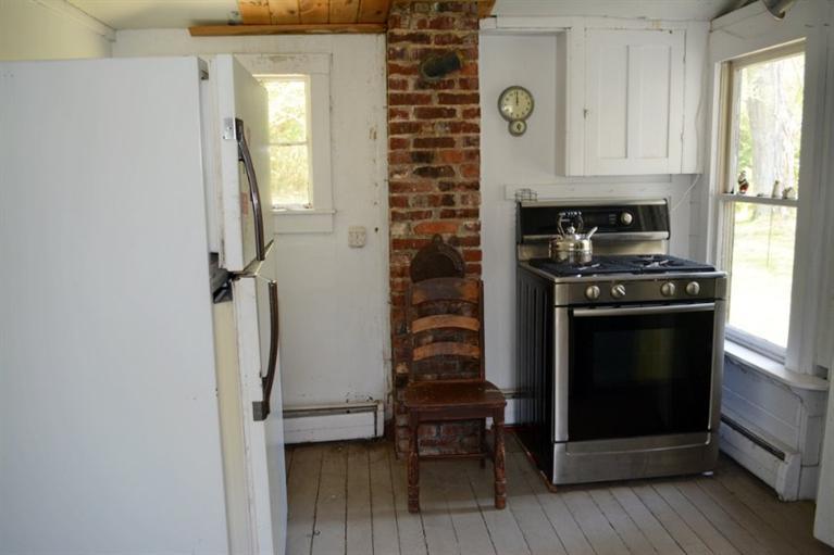 5 Atwood Road Truro, MA 02666 - Photo 10 of 24 a kitchen with granite countertop a stove and a refrigerator
