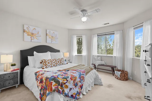 a bedroom with a bed and a window