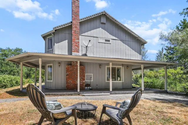 a dining room with furniture and potted plant