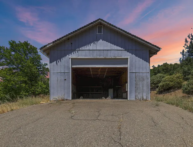 a living room with furniture a fireplace and a floor to ceiling window