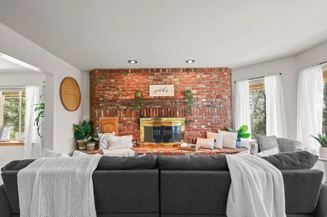 an aerial view of residential house with outdoor space and trees all around
