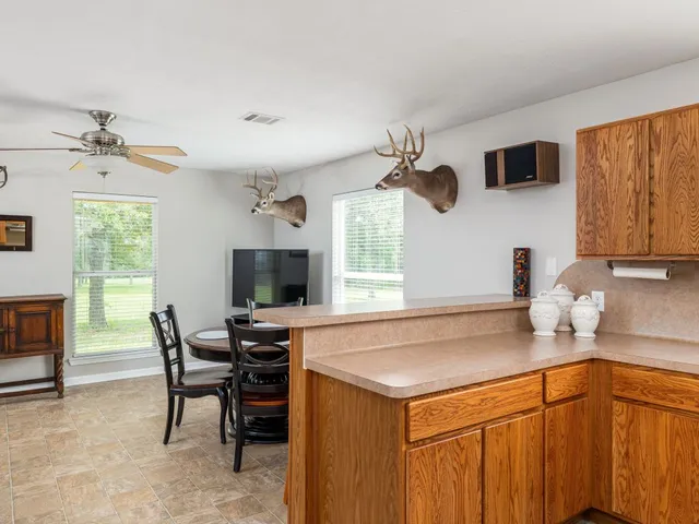 a kitchen with a sink cabinets and window