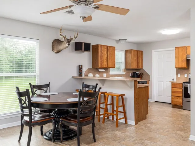 a view of a dining room with furniture and a kitchen