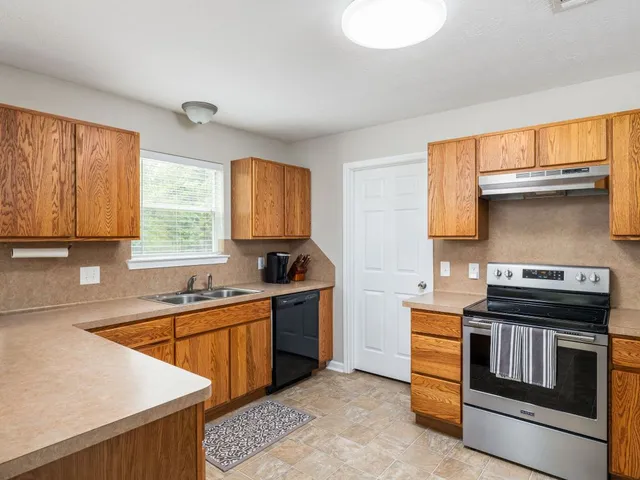 a kitchen with stainless steel appliances a stove sink and cabinets