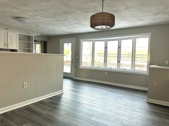a view of an empty room with a fireplace