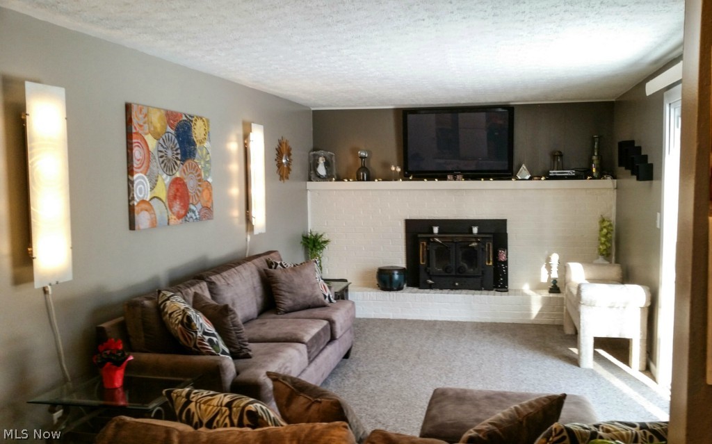 4245 Hile Road Stow, OH 44224 - Photo 10 of 25 Family room with neutral carpet and decor. Slider on right leads to deck and backyard.