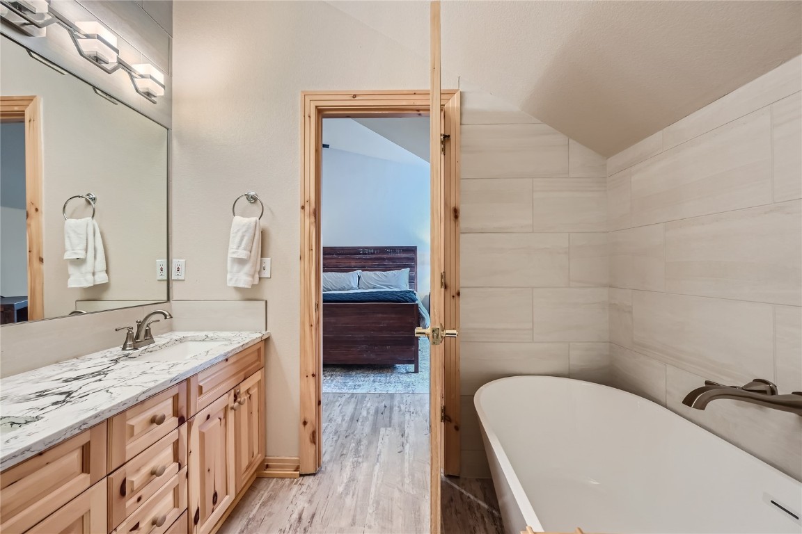 400 Kings Crown Road, Unit 400 Breckenridge, CO 80424 - Photo 13 of 40 a bathroom with a tub sink and mirror