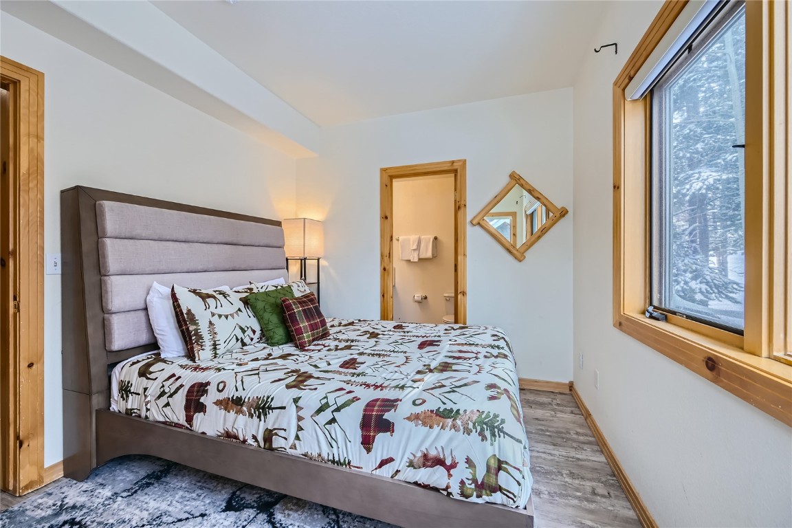 400 Kings Crown Road, Unit 400 Breckenridge, CO 80424 - Photo 20 of 40 a bedroom with a large bed and a window