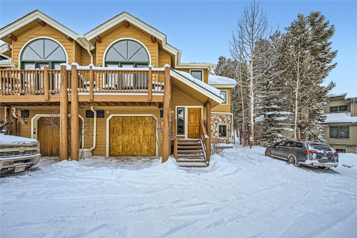 400 Kings Crown Road, Unit 400 Breckenridge, CO 80424 - Photo 25 of 40 a view of a big house with large windows and a small yard