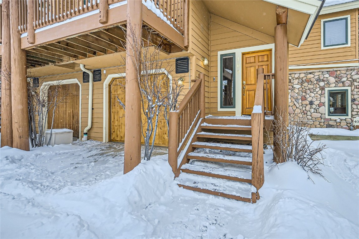 400 Kings Crown Road, Unit 400 Breckenridge, CO 80424 - Photo 26 of 40 a view of a porch with wooden floor and stairs