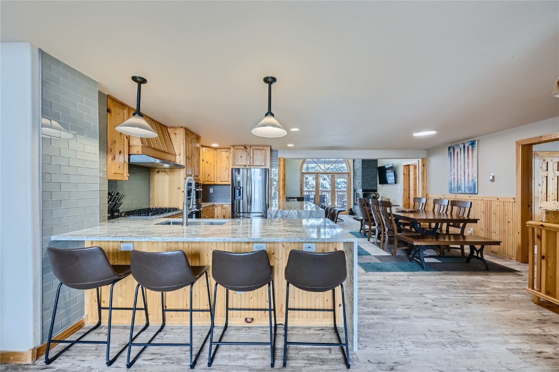 400 Kings Crown Road, Unit 400 Breckenridge, CO 80424 - Photo 5 of 40 a kitchen with a dining table chairs cabinets and stainless steel appliances