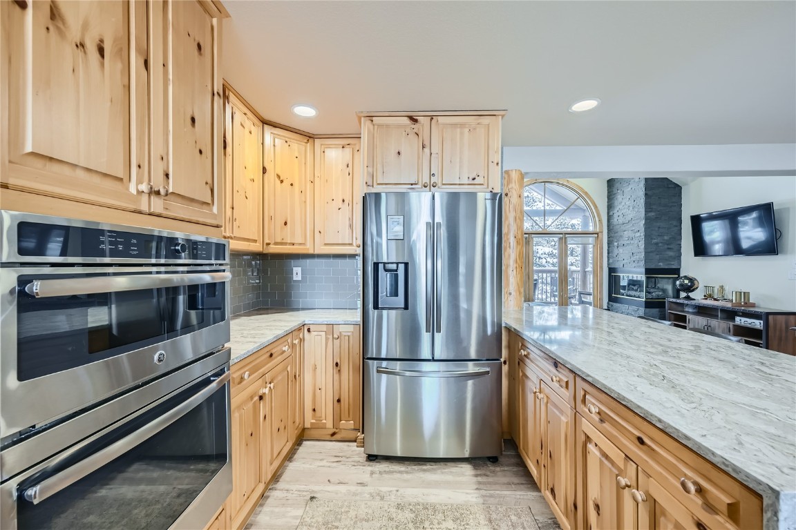 400 Kings Crown Road, Unit 400 Breckenridge, CO 80424 - Photo 6 of 40 a kitchen with stainless steel appliances granite countertop a refrigerator a stove and a sink with cabinets