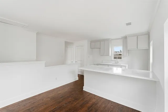a kitchen with wooden floor and window