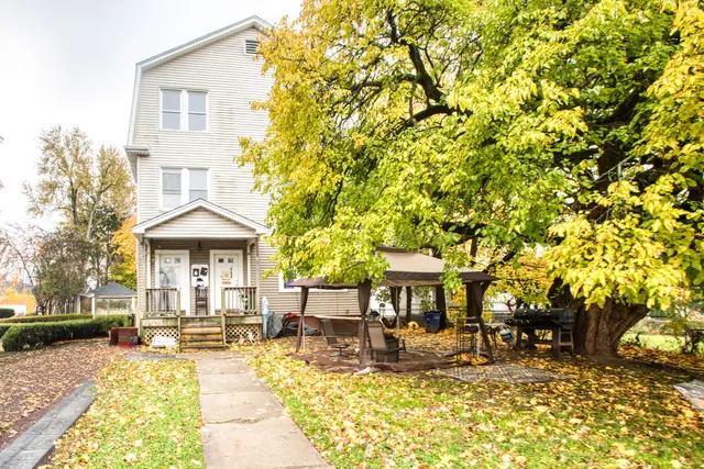 a view of a house with backyard porch and sitting area