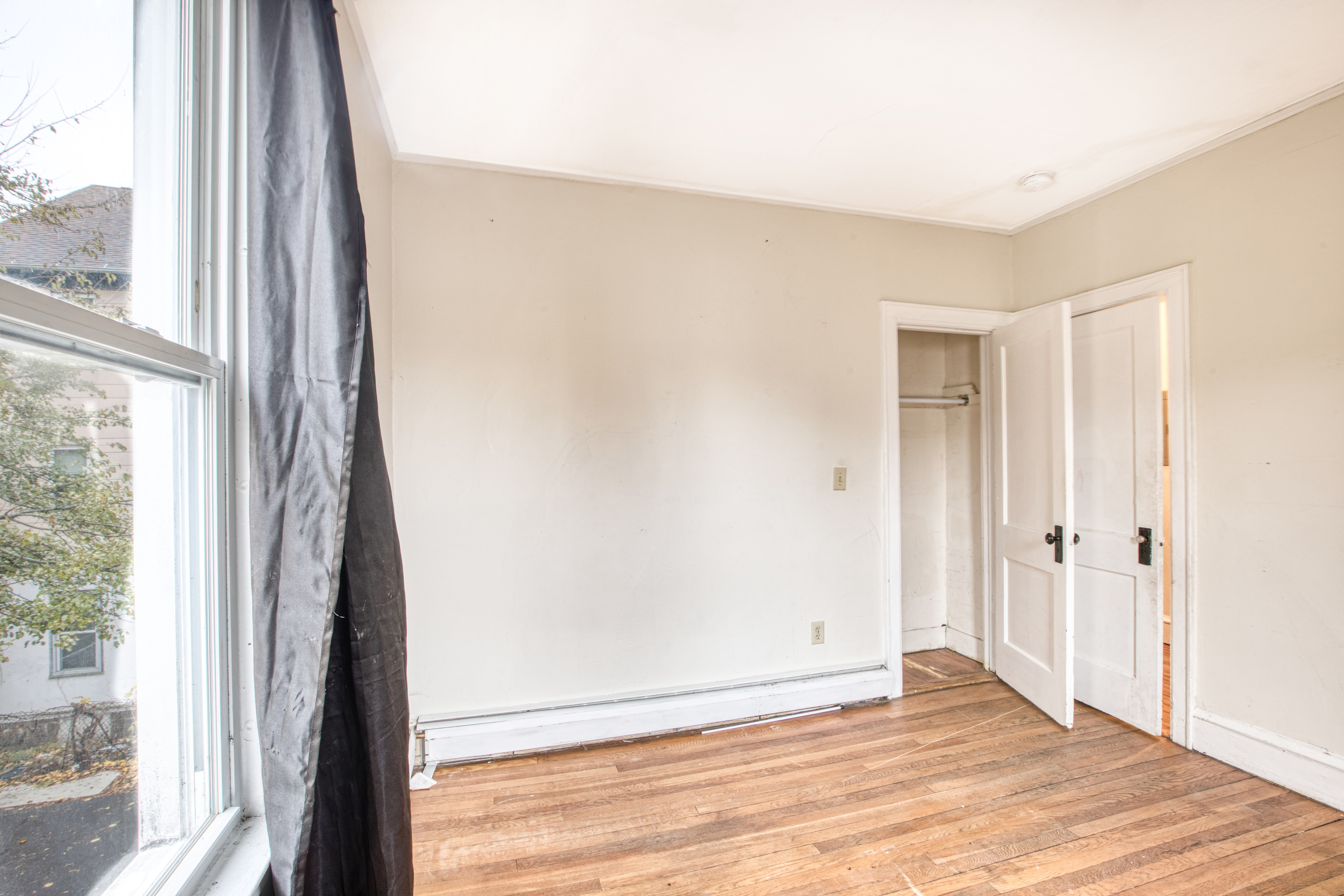 429 New Britain Avenue Hartford, CT 06106 - Photo 12 of 20 an empty room with wooden floor and windows