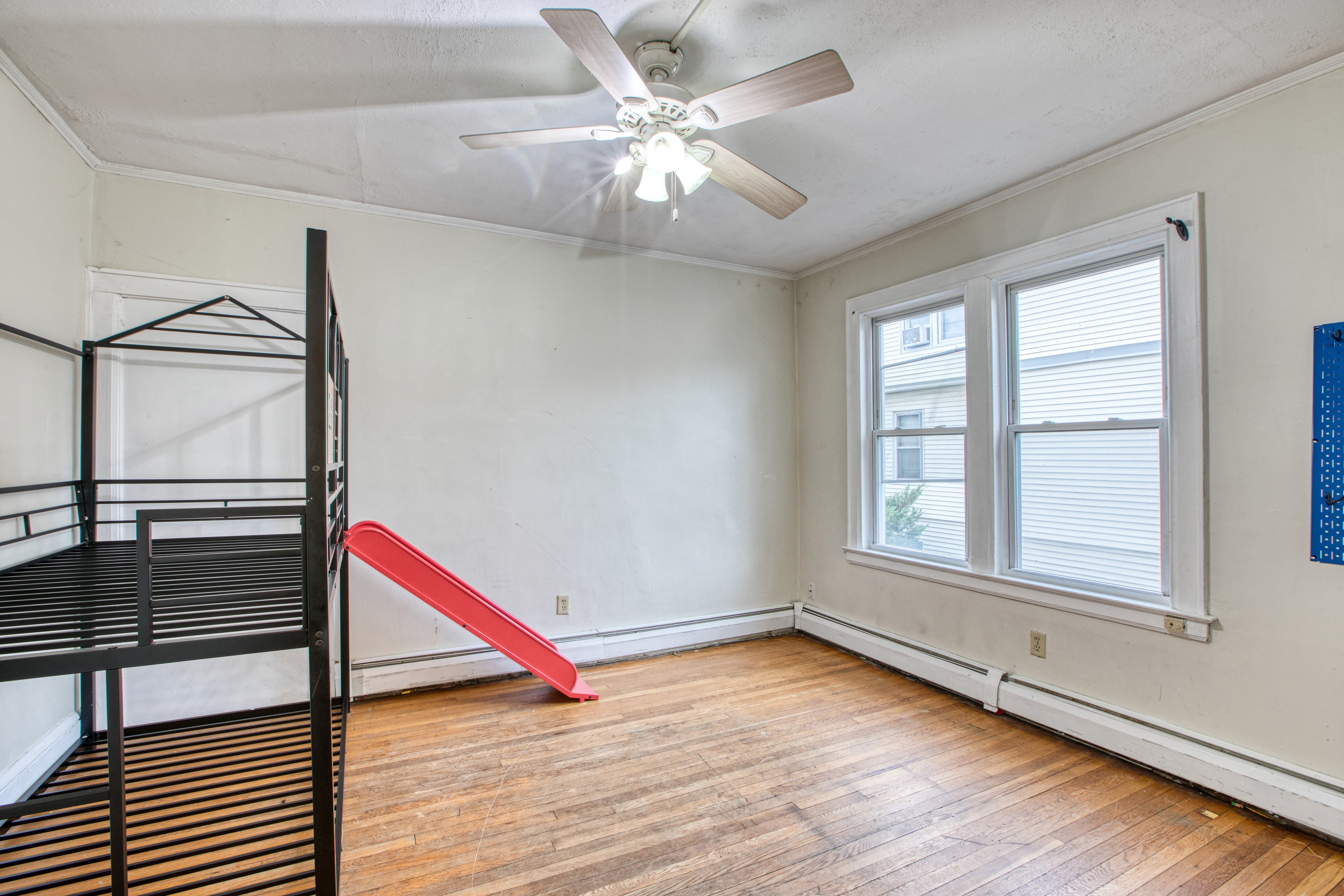429 New Britain Avenue Hartford, CT 06106 - Photo 16 of 20 an empty room with wooden floor and windows