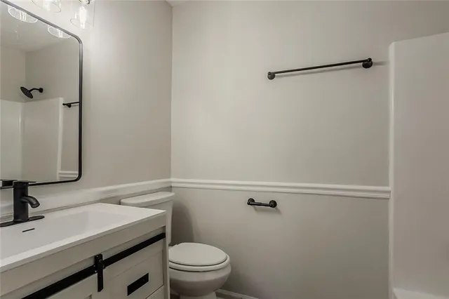 a bathroom with a sink a toilet and a mirror