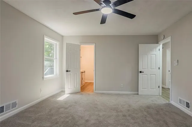 a view of an empty room with a window