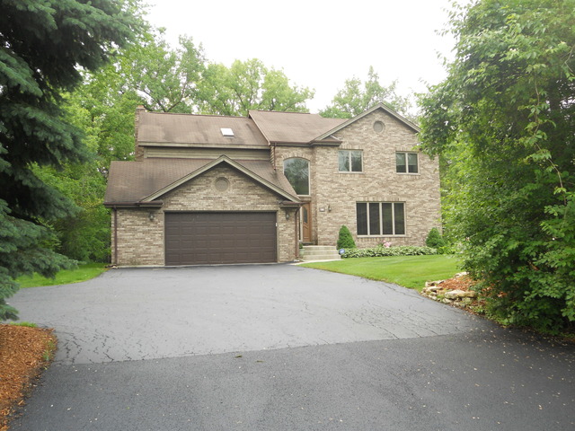 97 Monee Road Park Forest, IL 60466 - Photo 1 of 25 a front view of a house with a yard and garage