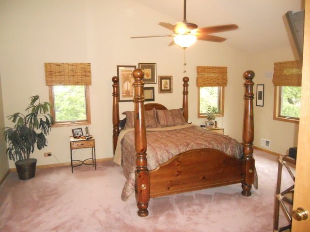 97 Monee Road Park Forest, IL 60466 - Photo 11 of 25 a bedroom with a bed and a chandelier