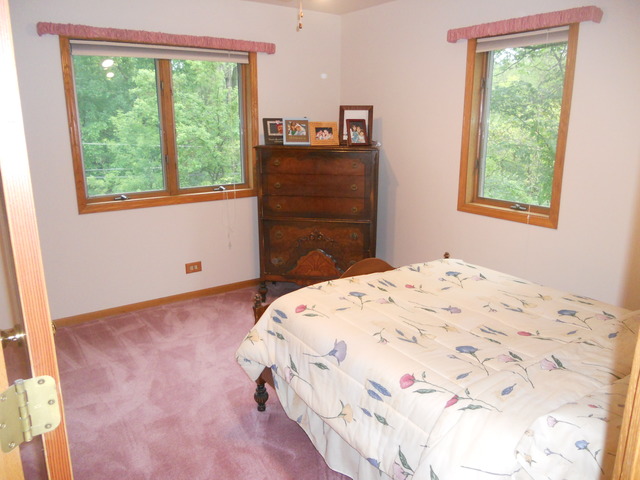 97 Monee Road Park Forest, IL 60466 - Photo 15 of 25 a bedroom with a bed and a window