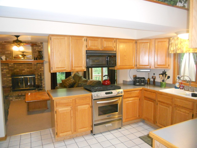 97 Monee Road Park Forest, IL 60466 - Photo 7 of 25 a kitchen with a stove a sink and a refrigerator