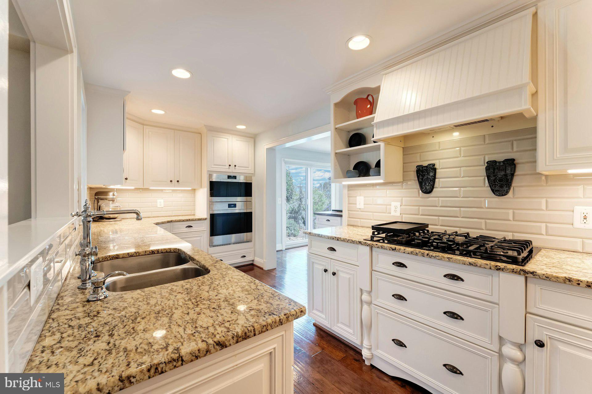 16555 Old Waterford Road Paeonian Springs, VA 20129 - Photo 20 of 92 a kitchen with white cabinets and appliances