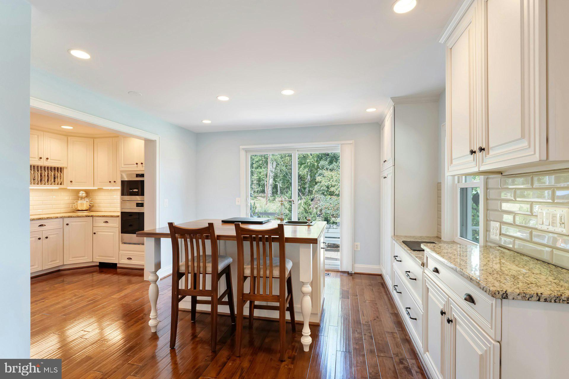16555 Old Waterford Road Paeonian Springs, VA 20129 - Photo 21 of 92 a kitchen with stainless steel appliances granite countertop a stove a refrigerator a kitchen island and chairs with wooden floor