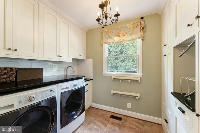a bathroom with a tub a sink and a large mirror