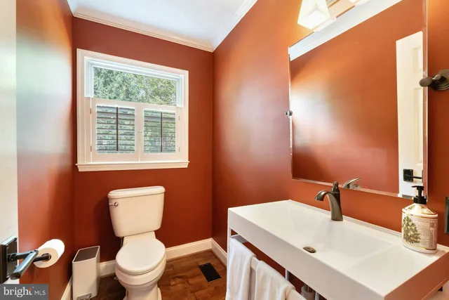 a view of a patio with table and chairs potted plants and large tree
