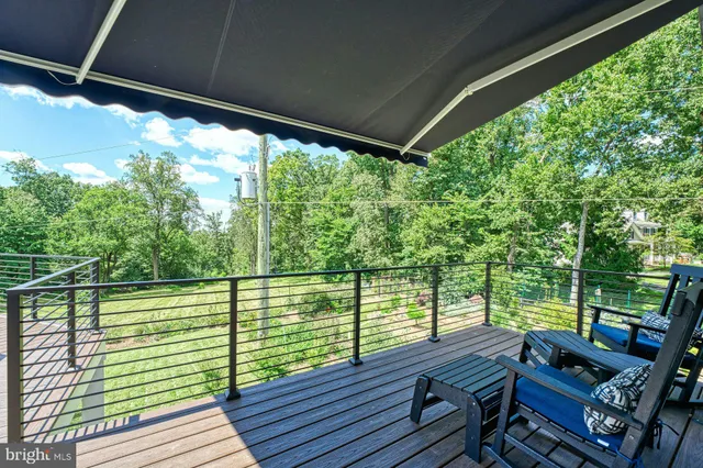 a kitchen with stainless steel appliances granite countertop a refrigerator a stove top oven a sink dishwasher and white cabinets with wooden floor