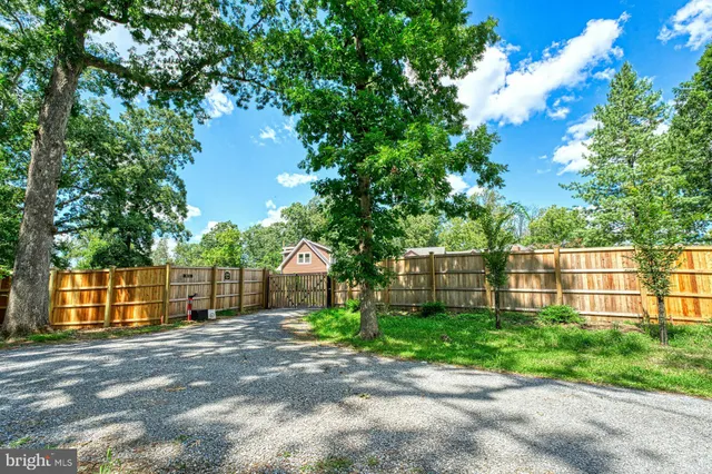 a view of a house with a yard and potted plants