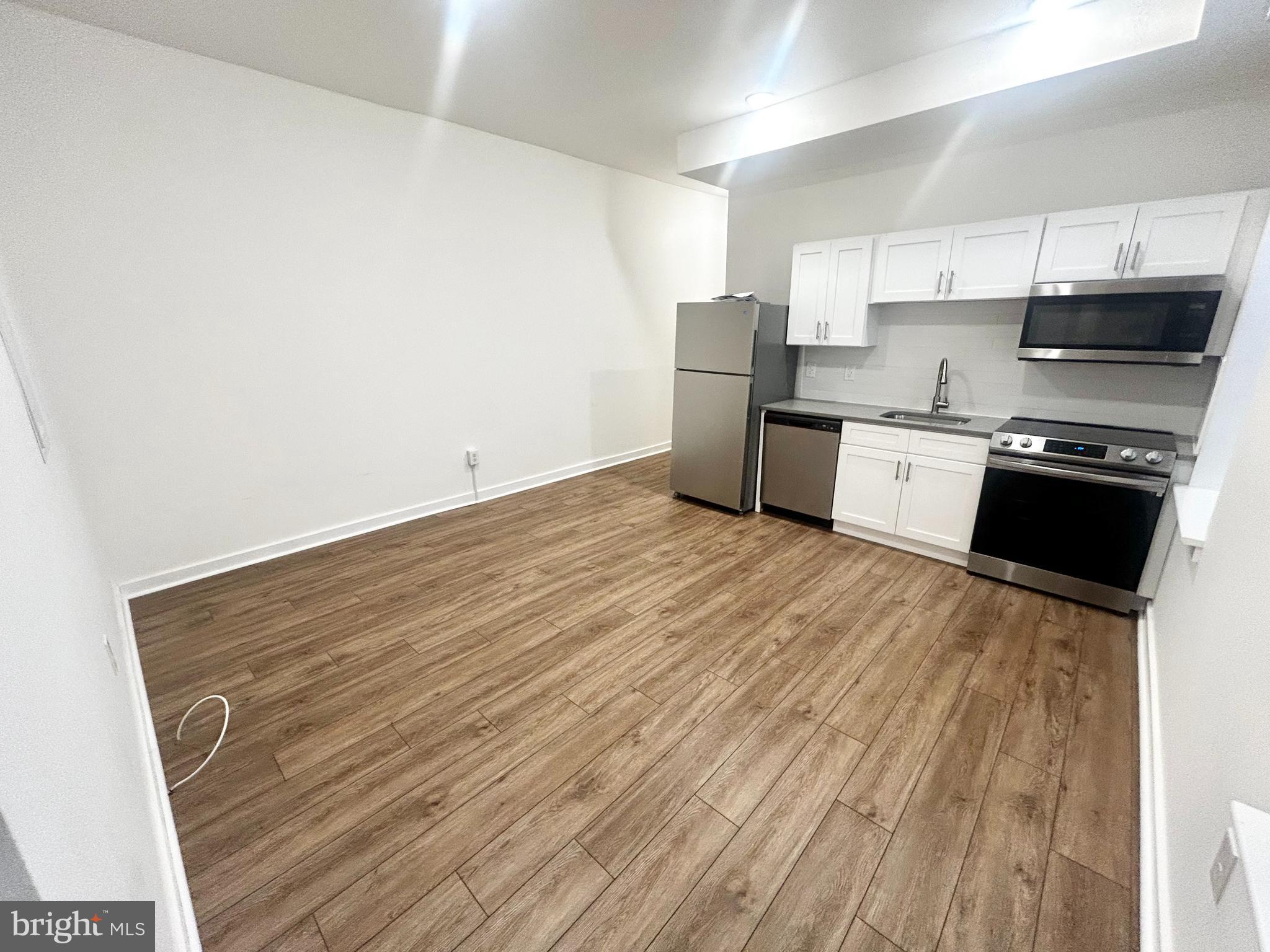 405 South 42nd Street, Unit 1R Philadelphia, PA 19104 - Photo 3 of 10 a kitchen with stainless steel appliances a refrigerator sink and cabinets