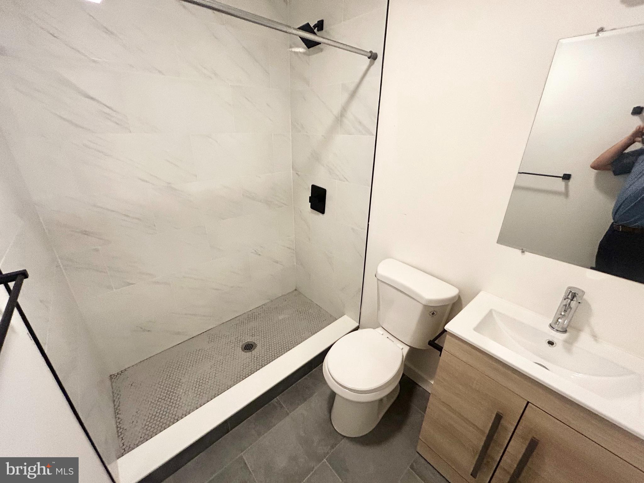 405 South 42nd Street, Unit 1R Philadelphia, PA 19104 - Photo 8 of 10 a white toilet sitting next to a bathroom sink