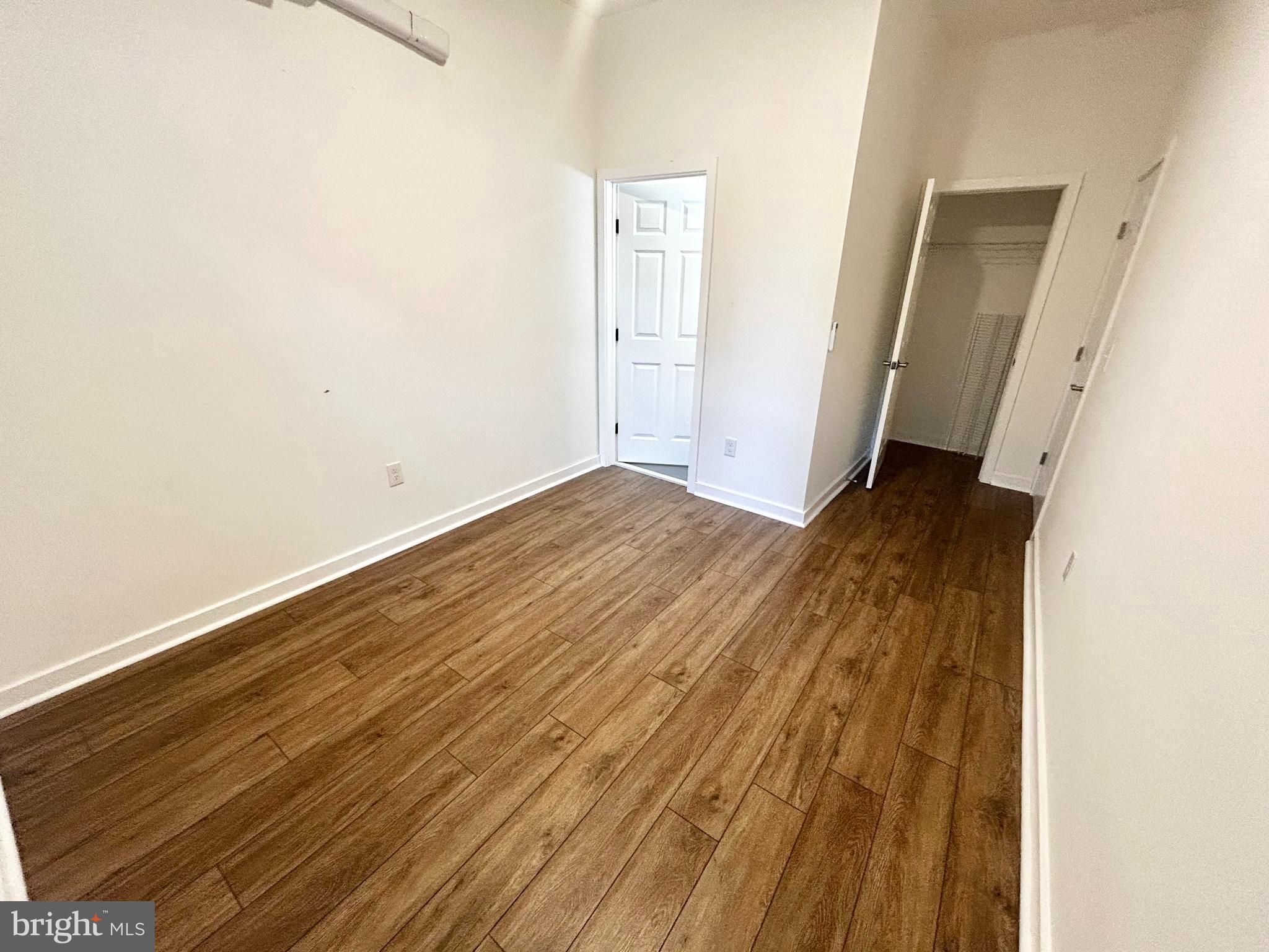405 South 42nd Street, Unit 1R Philadelphia, PA 19104 - Photo 9 of 10 an empty room with wooden floor