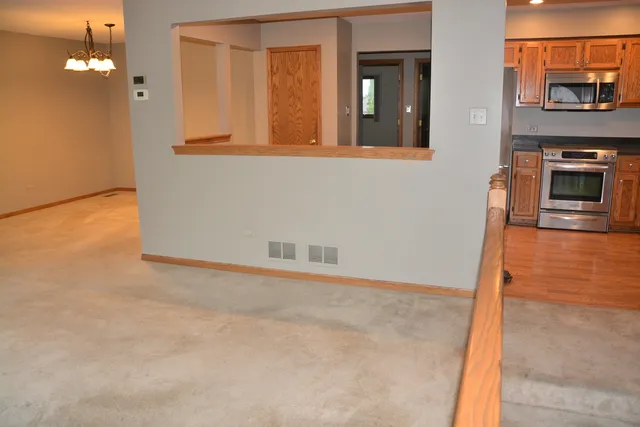 view of an empty room with wooden floor and a fireplace