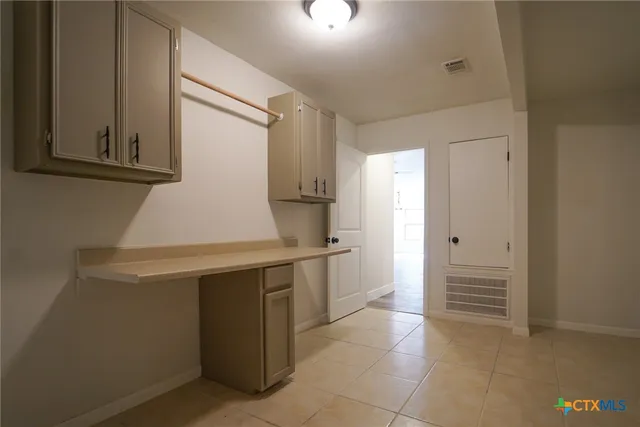 a kitchen with a refrigerator and cabinets