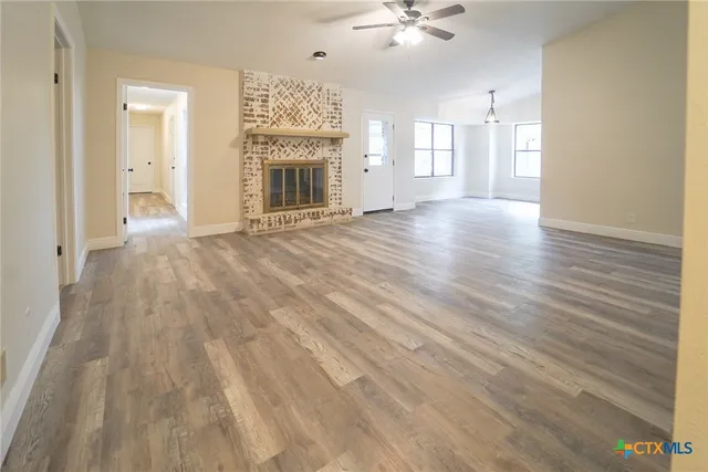 wooden floor in an empty room with a fireplace