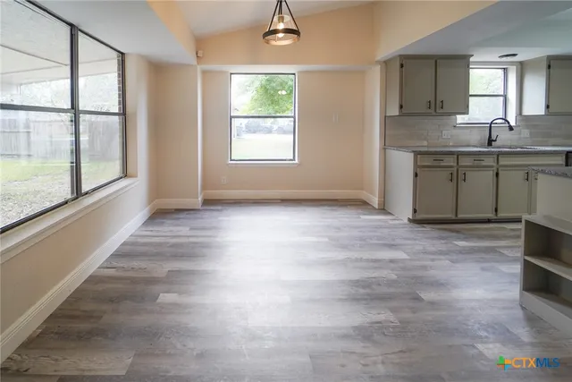 a view of a kitchen with a sink cabinet and a window